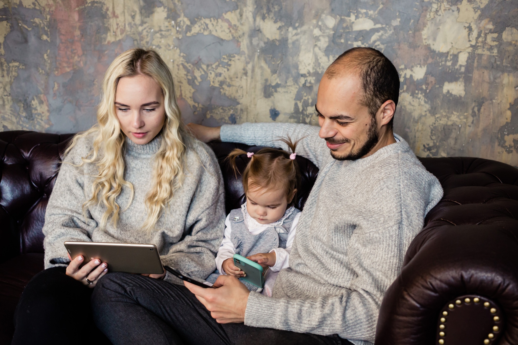 Family with kid relax with gadget